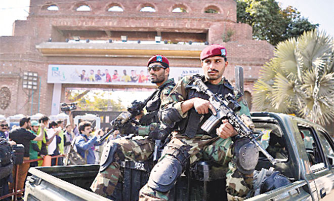 Tight Security: Soldiers stand guard as fans queue up outside the stadium ahead of the PSL 2017 final. Security will remain a major issue if PSL matches are staged on home soil next year.