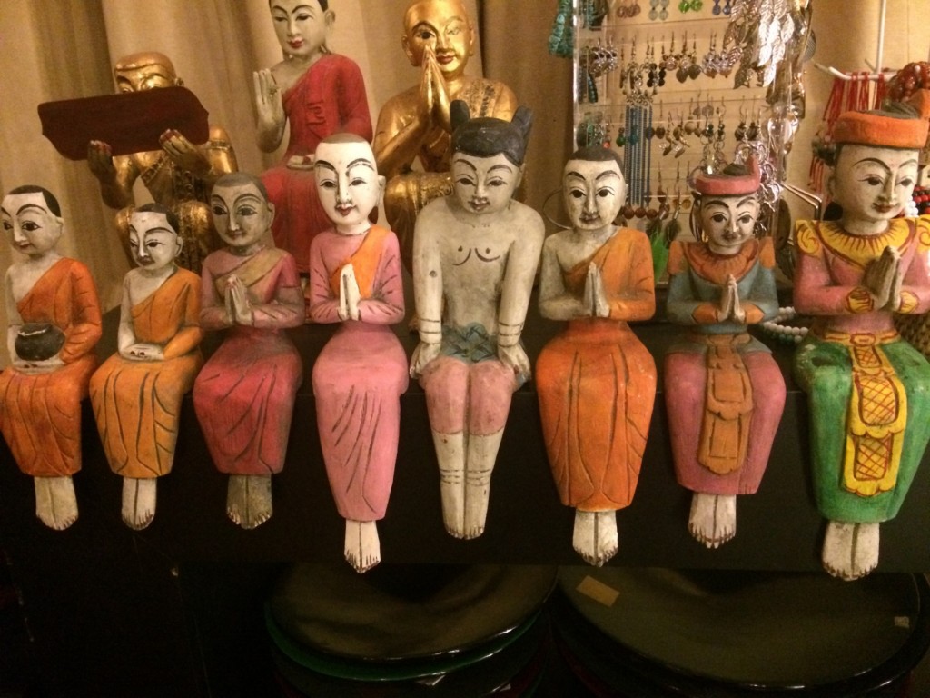 Handmade wooden statuettes of monks and pilgrims on sale.