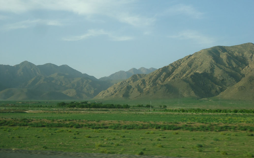 The sandy expanses between rugged hills are rendered colorful by spring in the valley of Mastung.