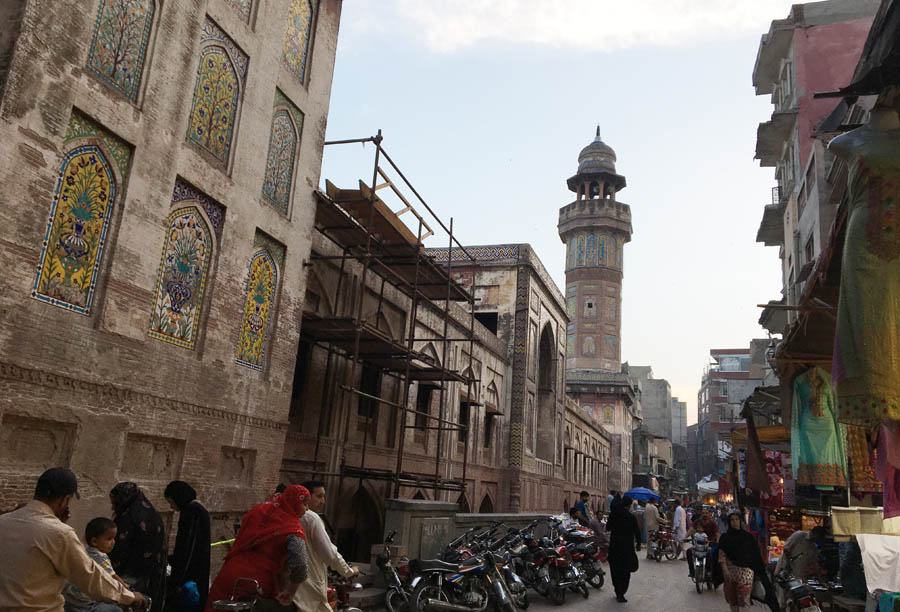 Work in progress: the exterior wall of the Wazir Khan Mosque that runs alongside the bazaar .