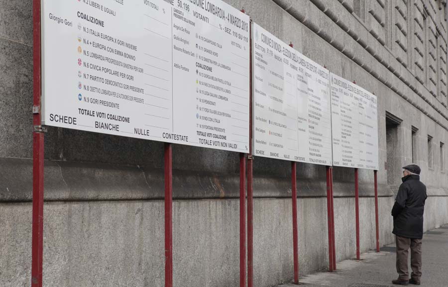 How did our town vote_ A man looks at the board before election results are shared for all to see in the town center.