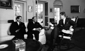 John F. Kennedy (right, in rocking chair) meets with Pakistani Foreign Minister M. Ali Bogra (centre) and Ambassador Aziz Ahmed (left) at the White House.