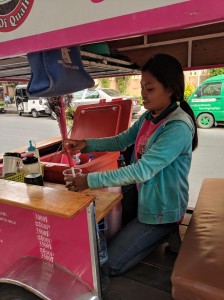 Women ride scooters and (wo)man their own roadside businesses.