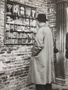 Ben Shahn looking at postcards in a museum in Italy 1956.