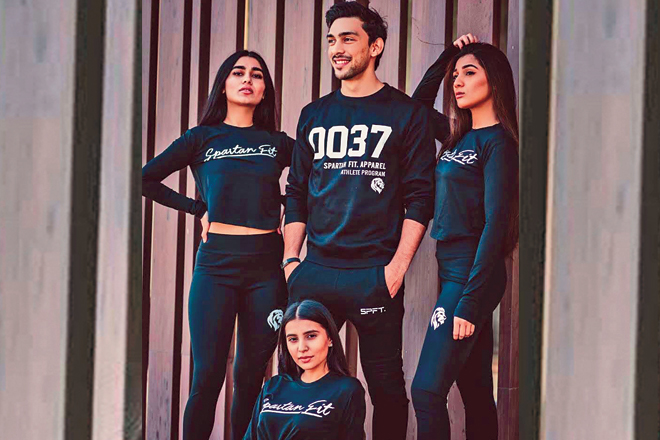 Models and influencers sporting Spartan Fitness athleisure line that includes t-shirts, leggings and sweatshirts. 