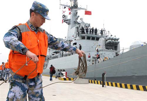 A Chinese navy soldier helps anchor a frigate of the Pakistani Navy at a military port in east China's Shanghai.