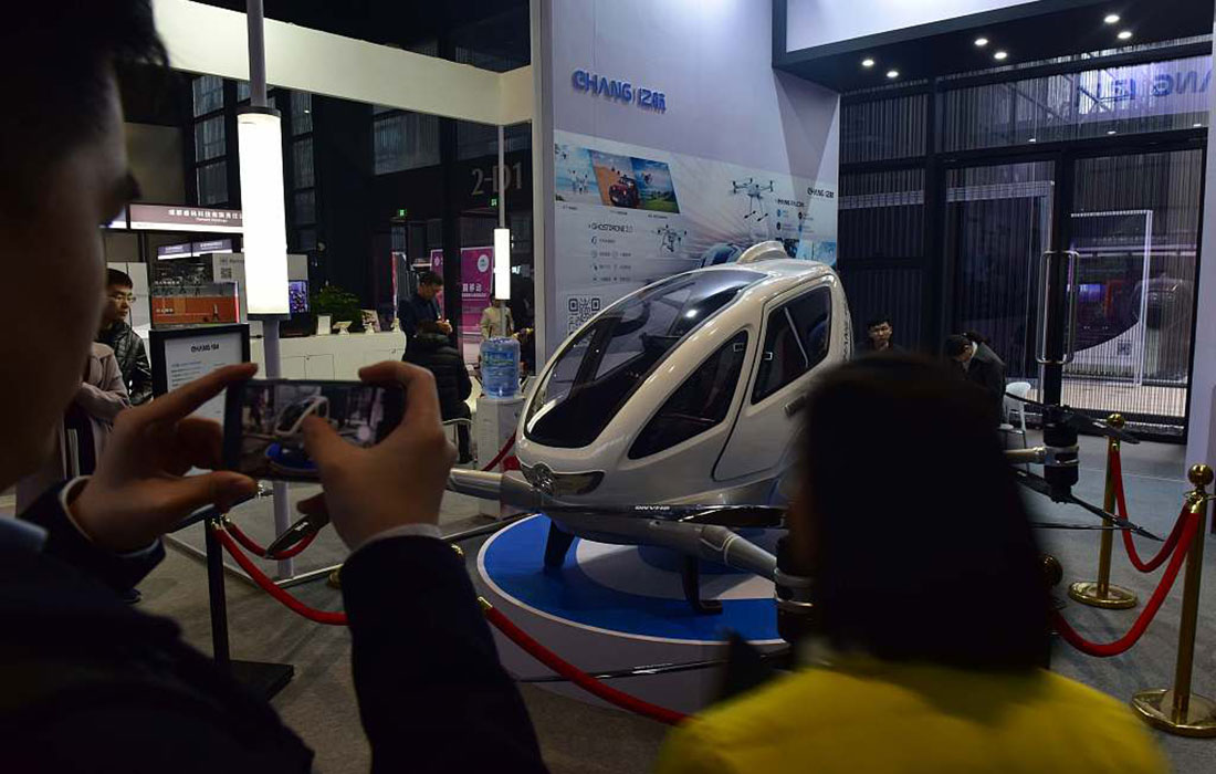 Visitors view an intelligent single-seat aircraft on display at the Fourth World Internet Conference.