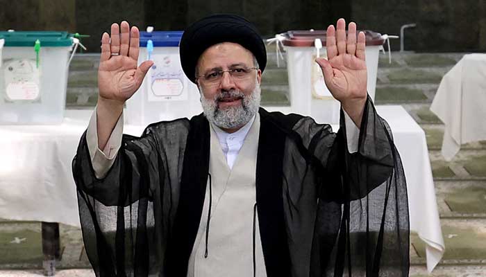 Presidential candidate Ebrahim Raisi waves after casting his ballot for presidential election, in Tehran, on June 18, 2021. -AFP