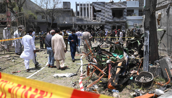 Security officials inspect the site of an explosion that killed at least three people and wounded several others in Lahore on June 23, 2021. — AFP/File
