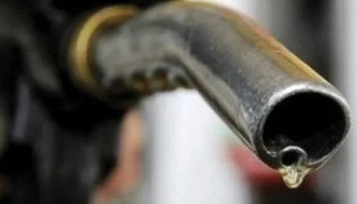 Petrol can be seen dripping out of a nozzle. — AFP/File