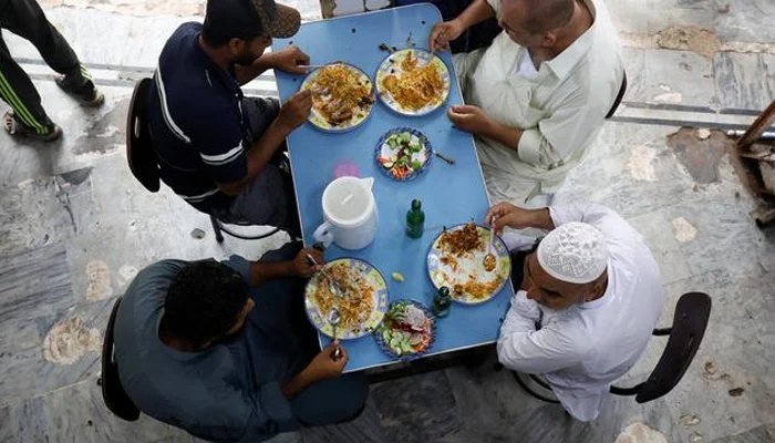 Picture showing four people enjoying a meal at a restaurant. Photo: File.