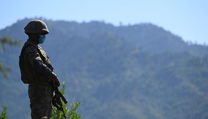 A Pakistani soldier stands guard near the Line of Control, de facto border between India and Pakistan at Salohi village in Poonch district of Azad Jammu and Kashmir on April 26, 2021. — AFP/File