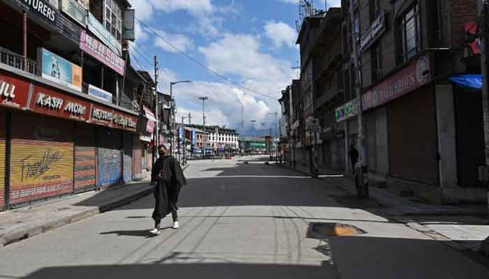 A man wearing a facemask walks along a deserted street during a government-imposed nationwide lockdown as a preventive measure against the COVID-19 coronavirus, in Azad Kashmir on March 29, 2020. — AFP