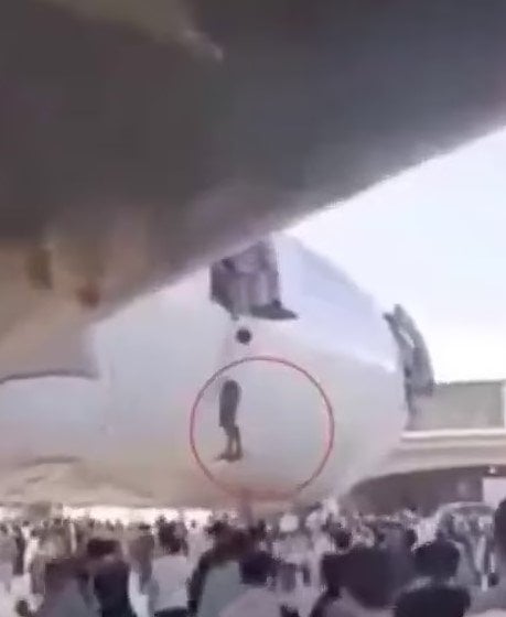 The footage showing desperate Afghans trying to climb on to the grounded planes at Kabuls Hamid Karzai Airport after the Taliban swept the city. Screengrab via Daily Mail.