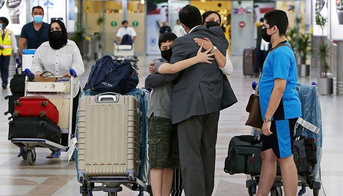 A man greets his family upon their arrival at Kuwait international airport on August 1, 2021. — AFP/File