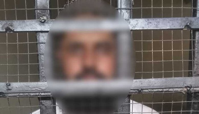 Suspected seminary cleric behind the bars post arrest. Photo Geo News