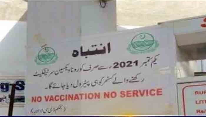 No vaccination, no service, reads a banner outside a Lahore petrol pump.