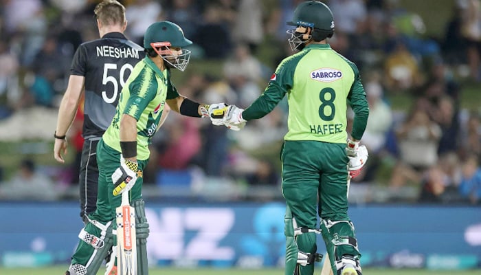 Pakistan batsman Mohammad Rizwan (L) celebrates hitting a six with a teammate Mohammad Hafeez during the third T20 cricket match between New Zealand and Pakistan at McLean Park on December 22, 2020. — AFP/File