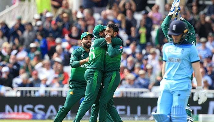 Mohammad Hafeez (3rd L) celebrates with teammates after taking the wicket of Englands Eoin Morgan. — AFP/File