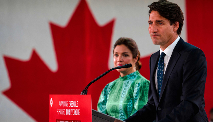 Canadian Prime Minister Justin Trudeau, flanked by wife Sophie Gregoire-Trudeau, delivers his victory speech after general elections at the Queen Elizabeth Hotel in Montreal, Quebec, early on September 21, 2021. — AFP