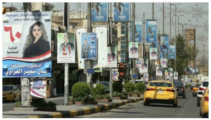 Election campaign banners put up by a road in Iraq — AFP