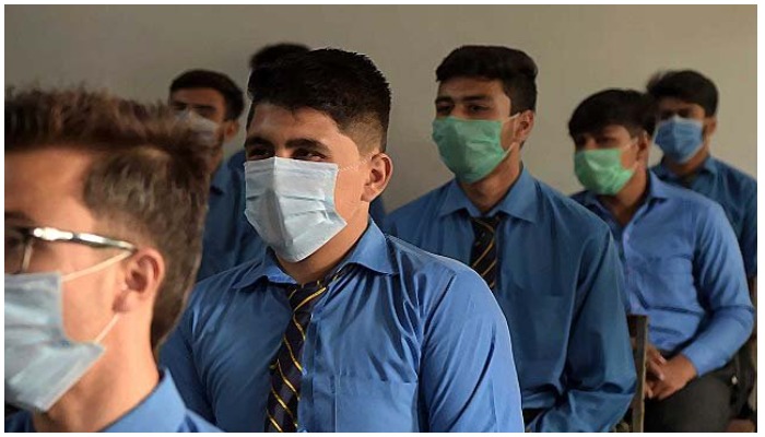 Students wear protective masks in class at a school in Pakistan. Photo: AFP