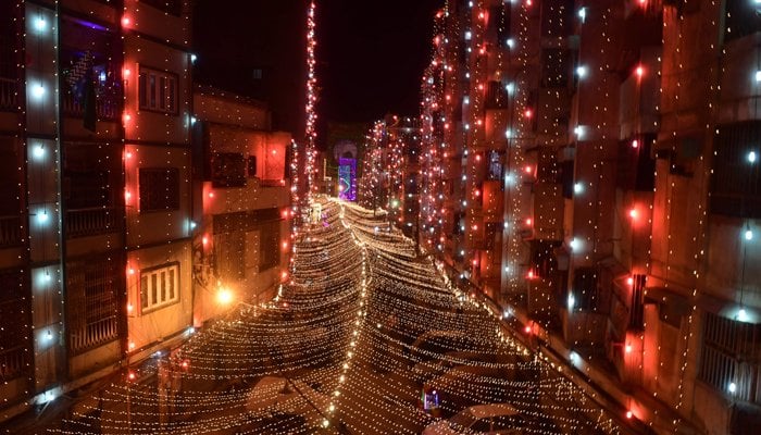 A picture taken on October 28, 2020 an illuminated street in a residential area ahead of celebrations for Eid-e-Milad-un-Nabi, the birth anniversary of Holy Prophet Mohammad (PBUH), in Pakistan port city of Karachi. — AFP