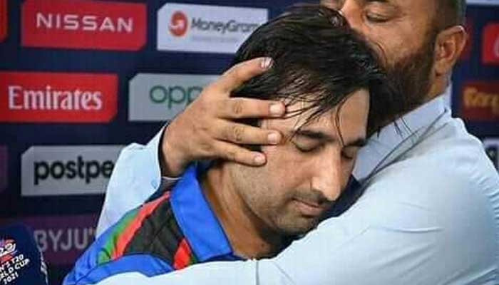 Asghar Afghan being consoled by his translator. Photo: Twitter