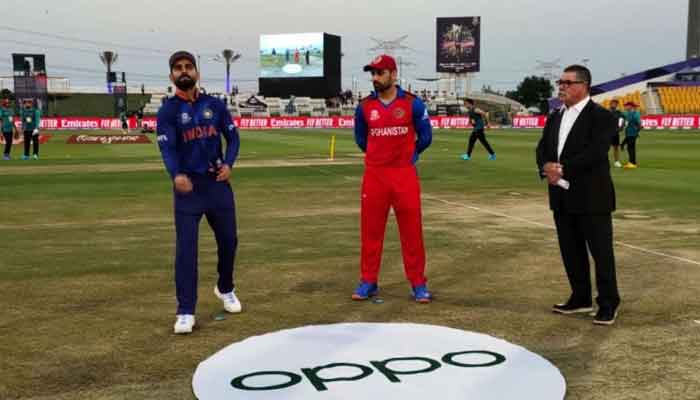 Indian skipper Virat Kohli flips the coin while Afghanistan captain Mohammad Nabi watches. Photo: Twitter