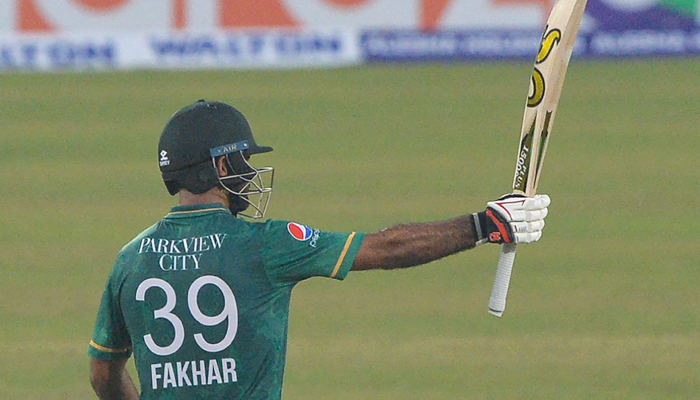 Pakistans Fakhar Zaman raises his bat to celebrate a half century (50 runs) during the second Twenty20 international cricket match between Bangladesh and Pakistan at the Sher-e-Bangla National Cricket Stadium in Dhaka on November 20, 2021. — AFP