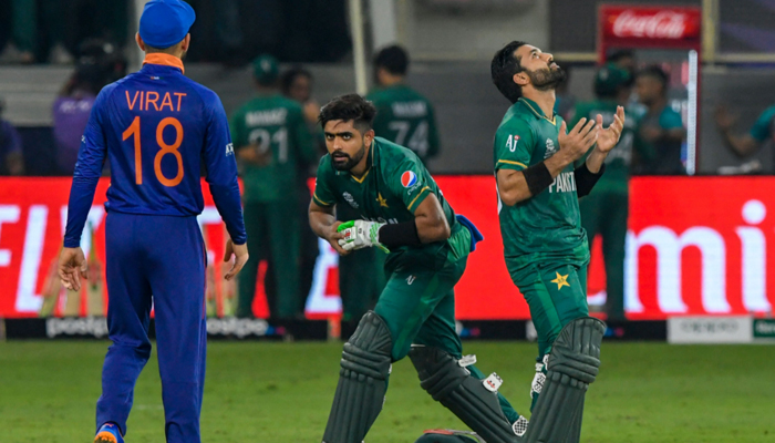 Pakistans team captain Babar Azam (C) and his teammate Mohammad Rizwan (L) react following their victory as Indias captain Virat Kohli looks on during the ICC Twenty20 World Cup cricket match between India and Pakistan at the Dubai International Cricket Stadium in Dubai on October 24, 2021. — AFP/File