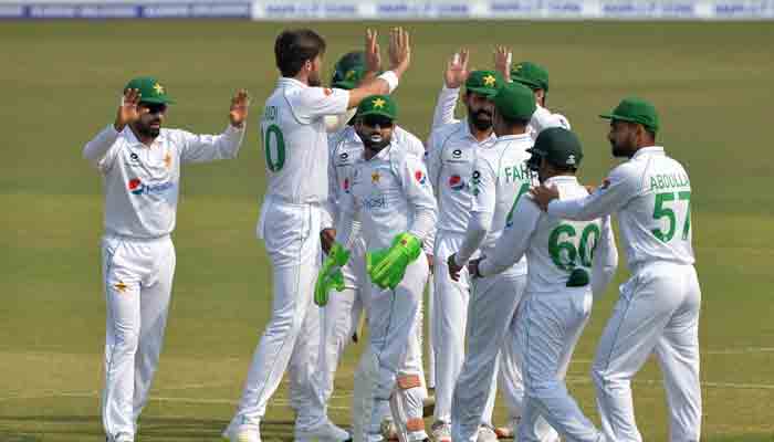 Shaheen Afridi celebrates the wicket of Said Hassan with his teammates. -AFP