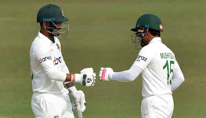 Liton Das and Mushfiqur Rahim bump fists during their stand against Pakistan in the first Test.-AFP