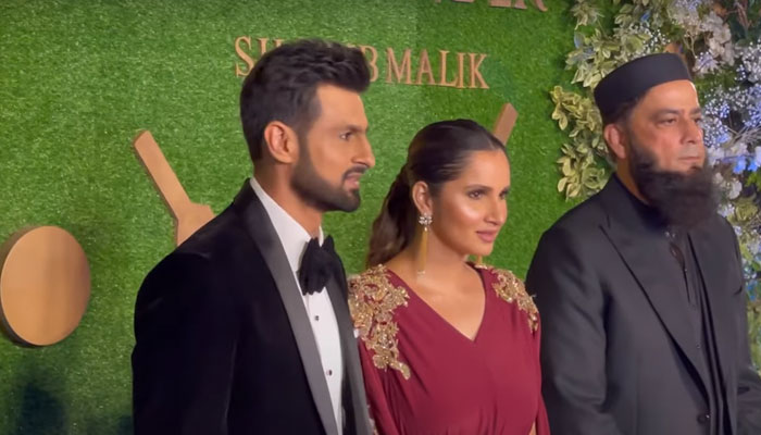 Indian tennis star Sania Mirza and her husband Shoaib Malik pose for photographers during the launch ceremony of their perfume brand in Karachi.