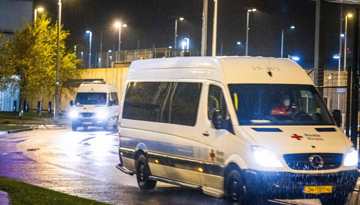 A Red Cross van transporting passengers of flights from South Africa who have tested positive for COVID-19 drives to a hotel where they will be quarantined on November 27, 2021, at Amsterdams Schiphol airport. Dutch health authorities said on November 27 that 61 passengers from two flights from South Africa tested positive for COVID-19 and the results were being examined for the new Omicron variant. — AFP