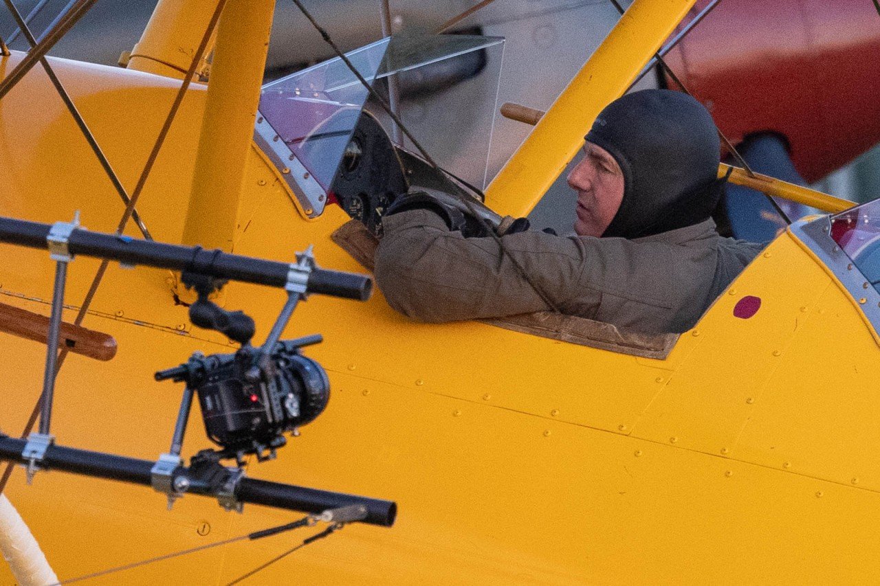 Tom Cruise hangs off airplane wing in new insane stunt. Watch