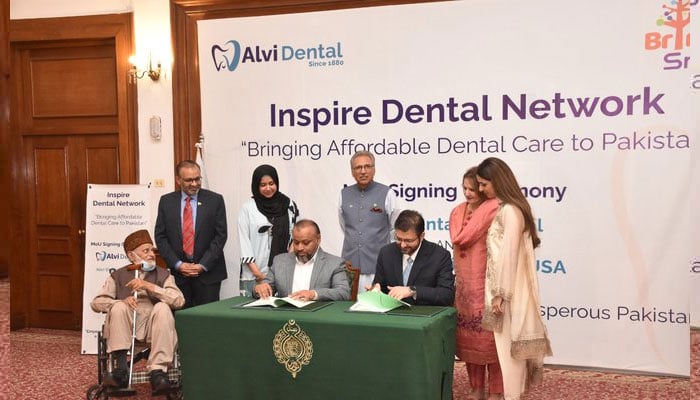 Dr Arif Alvi and his son Awab Alvi during the MoU signing between Alvi Dental and Bringing Smiles USA. — Twitter/Awab Alvi