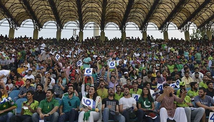 Cricket fans enjoy the International T20 cricket match between Zimbabwes and Pakistani teams at the Gaddafi Cricket Stadium in Lahore on May 24, 2015. — AFP/File