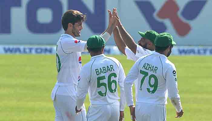 Pakistan players congratulate Shaheen Afridi after taking a wicket in the second Test against Bangladesh. -AFP