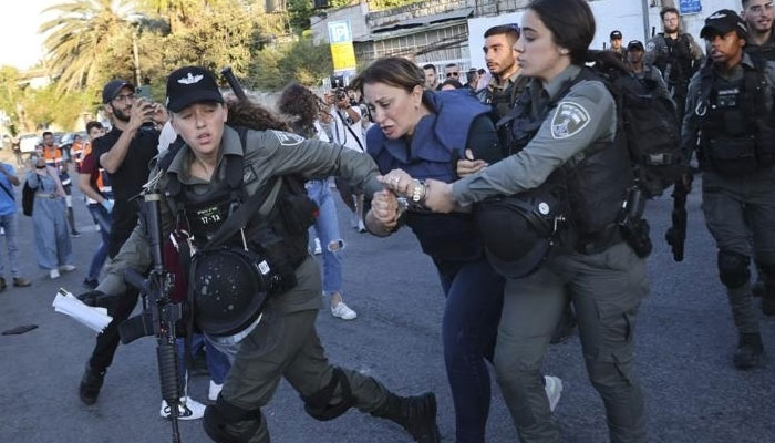 Israeli forces arrest Al Jazeera journalist, Givara Budeiri, during a protest in the east Jerusalem neighbourhood of Sheikh Jarrah on June 6, 2021. Photo: AP