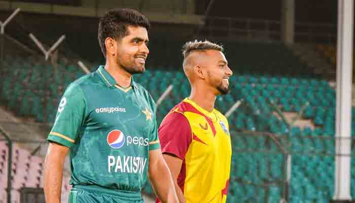 Pakistan skipper Babar Azam (L) and West Indian captain Nicholas Pooran during the trophy unveiling ceremony at the National Stadium Karachi.-PCB