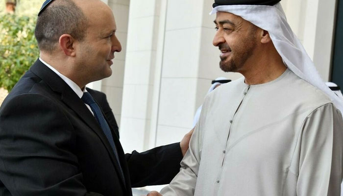 A handout picture from the Israeli Government Press Office shows Abu Dhabis Crown Prince Sheikh Mohammed bin Zayed Al-Nahyan (R), receiving Israeli Prime Minister Naftali Bennett (L) on December 12, 2021 - GPO/AFP