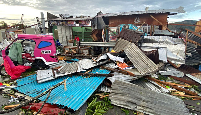 This photo taken on December 17, 2021 shows a resident salvaging belongings among debris caused by Super Typhoon Rai after the storm crossed over Surigao City in Surigao del Norte province.— AFP/File
