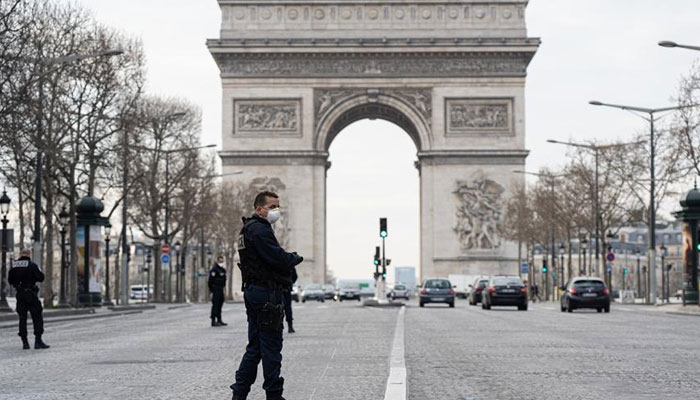 Police patrol near the Arc de Triomphe on the first day of confinement in 2020 due to COVID-19, Paris, France. File photo
