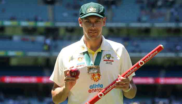 Player of the match Australias paceman Scott Boland celebrates with the Mullagh Medal after Australia won the match and retained the Ashes at the end of the third Ashes cricket Test match between Australia and England in Melbourne on December 28, 2021.-AFP