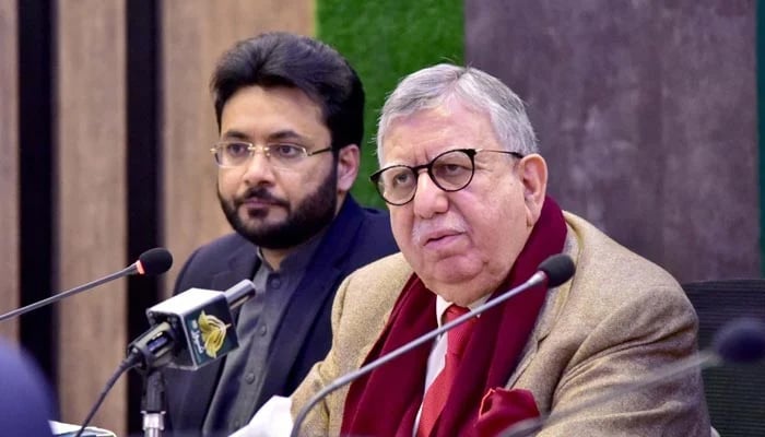 Federal Minister for Finance and Revenue Shaukat Tarin, addressing a press conference along with Minister of State for Information and Broadcasting Farrukh Habib on December 30, 2021. — PID