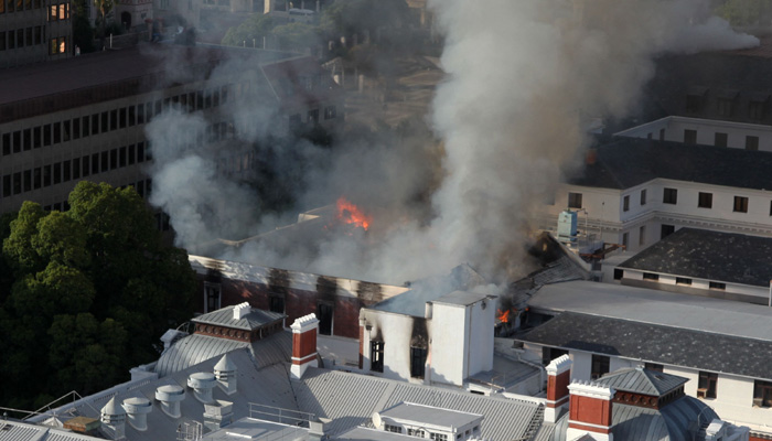 A general view of a building on fire at the South African Parliament precinct in Cape Town on January 2, 2022. — AFP
