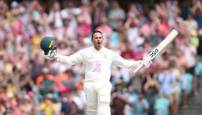 Australias Usman Khawaja celebrates reaching his century (100 runs) on day two of the fourth Ashes cricket Test match between Australia and England at the Sydney Cricket Ground (SCG) on January 6, 2022. -AFP
