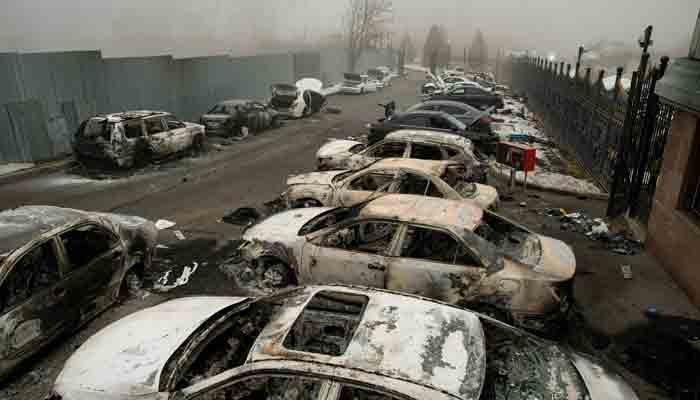 A picture shows a burnt-out cars in a parking area in central Almaty on January 6, 2022, after violence that erupted following protests over hikes in fuel prices.-AFP
