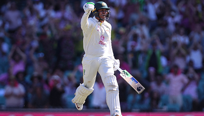 Australias Usman Khawaja celebrates reaching his century (100 runs) on day four of the fourth Ashes cricket test between Australia and England at the Sydney Cricket Ground (SCG) on January 8, 2022. — AFP